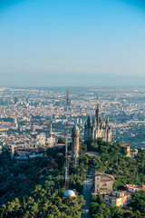 Naklejka premium Aerial views of the Tibidabo mountain from the helicopter in the city of Barcelona, catalonia