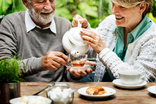 Senior couple having an afternoon tea break outdoors - Powered by Adobe
