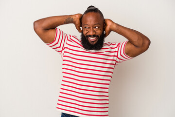 African american man with beard isolated on pink background stretching arms, relaxed position.
