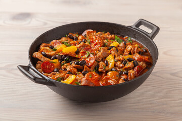 Pork stew with chorizo and black beans. Served with orange and seasoned with hot chili peppers....