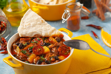 Pork stew with chorizo and black beans. Served with orange and seasoned with hot chili peppers. Perfect with tortillas.