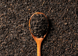 Background with tea leaves and a wooden spoon for the entire screen.