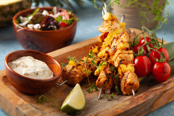 Grilled shashlik with salmon and pineapple. Served with yoghurt sauce.