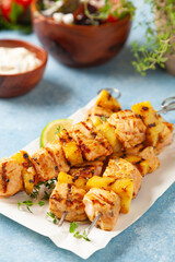 Grilled shashlik with salmon and pineapple. Served with yoghurt sauce.