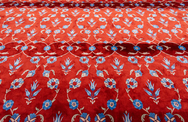 Part of red carpet or rug in muslim mosque.  Prayer mat in the Blue Mosque in Istanbul