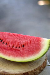 Slice of watermelon, served in a garden. Selective focus.