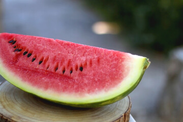 Slice of watermelon, served in a garden. Selective focus.