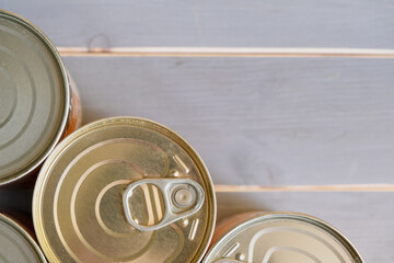 Tin cans of food. Several aluminum cans with long-term storage. View from above.