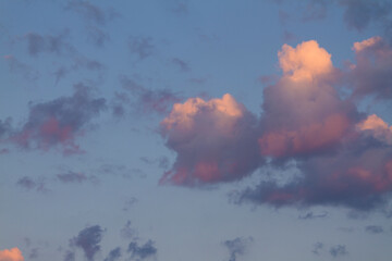 pink and lilac clouds at sunrise in summer morning