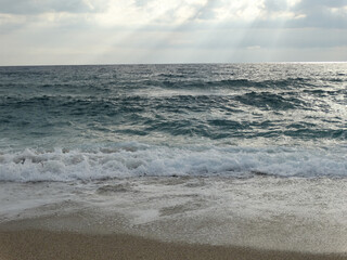 sea sun rays beach waves on the sea