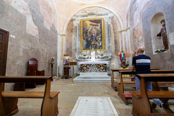 Fototapeta na wymiar Italy. Caserta. A Catholic believer prays in a church.