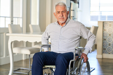 Senior sitzt nach einem Schlaganfall im Rollstuhl zu Hause - obrazy, fototapety, plakaty