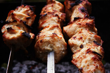 Cooking meat on the grill, barbecue, pieces of meat planted on a skewer. Roasting kebab on coals