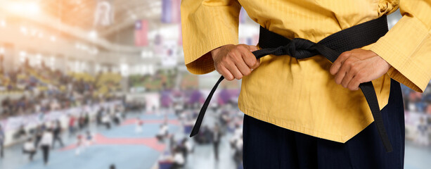 Master Black Belt TaeKwonDo Teacher hold  and tie belt pose