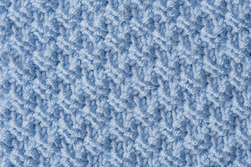 Knit texture of blue wool knitted fabric with pattern background.