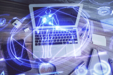 Education hologram drawings over computer on the desktop background. Top view. Multi exposure.