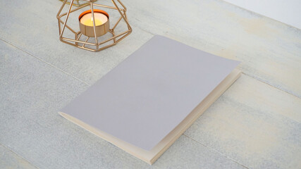 notebook in white background with decorative candle          