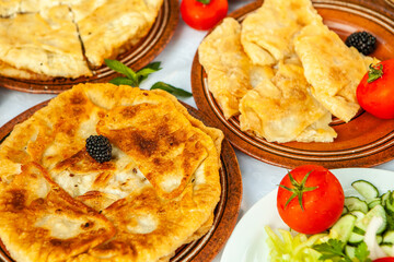 Traditional fried pies from Romania with potatoes, cheese and cabbage. Romanian food.