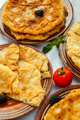 Traditional fried pies from Romania with potatoes, cheese and cabbage. Romanian food.