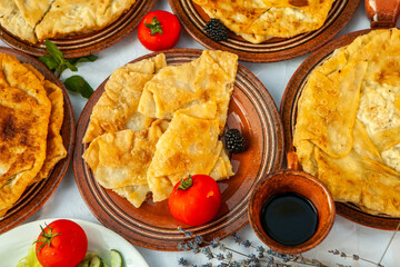 Traditional fried pies from Romania with potatoes, cheese and cabbage. Romanian food.