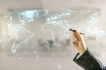 Man hand with pen working with abstract creative world map interface on blurred office background, international trading concept. Multiexposure