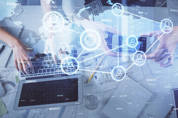 Double exposure of man and woman working together and social network theme hologram drawing. Computer background. connecting concept. Top View.