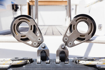 Part of the deck of a sailing yacht with fixing rollers and ropes on them and fasteners for...