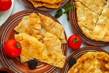 Traditional fried pies from Romania with potatoes, cheese and cabbage. Romanian food.