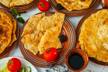 Traditional fried pies from Romania with potatoes, cheese and cabbage. Romanian food.