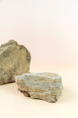 Stone podium for product displays on a pastel background. Ideal mock up for advertising. Vertical photo.