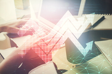 Double exposure of woman hands typing on computer and arrows drawing. Success concept.