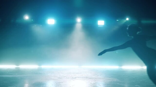 Skating rink with a young girl doing a jumping element