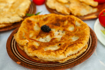Traditional fried pies from Romania with potatoes, cheese and cabbage. Romanian food.