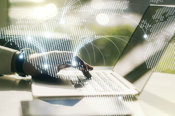 Double exposure of abstract digital world map with connections and hands typing on laptop on background, research and strategy concept