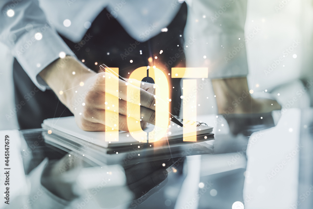 Poster creative iot hologram with man hand writing in notepad on background, internet of things concept. mu
