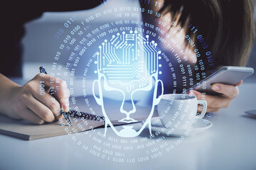 Double exposure of brain sketch hologram and woman holding and using a mobile device.