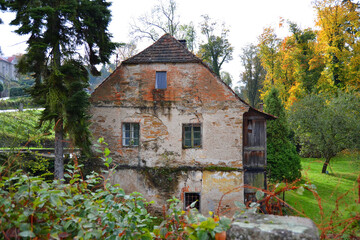 The old brick house in Žleby town in autumn time. Central Bohemian region, Czech Republic