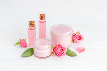 Essential rose aroma oil with cosmetic products for skin care