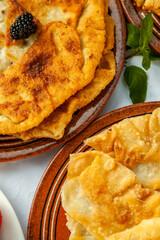 Traditional fried pies from Romania with potatoes, cheese and cabbage. Romanian food.