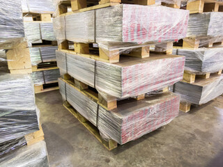 abstract industrial palleted production stacks indoors on the floor