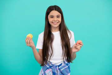 happy teen girl hold french macaron or macaroon cookies, confectionary