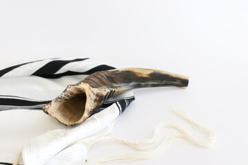 religion image of shofar (horn) on white prayer talit. Rosh hashanah (jewish New Year holiday), Shabbat and Yom kippur concept