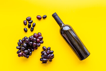Winery background. Red wine bottle with grapes
