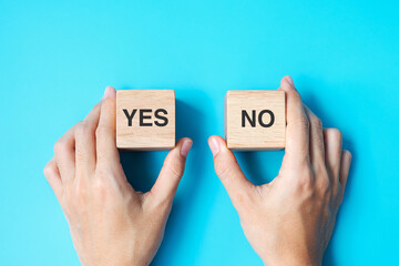 Hand choosing Yes or No block. Answer, question and decision concept