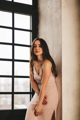  young gentle sexy girl with long hair on the background of a panoramic window.