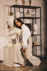 young sexy sculptor. girl near cultures. beauty, art.