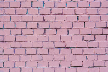 Old brick wall painted in pink. Texture of rough brickwork. Masonry background.
