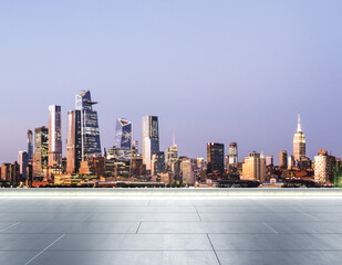 Empty concrete rooftop on the background of a beautiful blurry Manhattan skyline at twilight, mockup