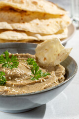 Baba ghanoush, babaganush or baba ganoush in gray bowl served with  oriental flatbread on concrete background. Turkish cuisine.