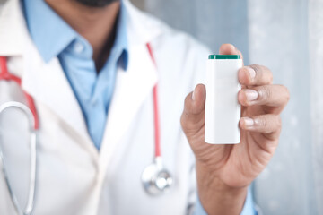 doctor hand holding artificial sweetener container 